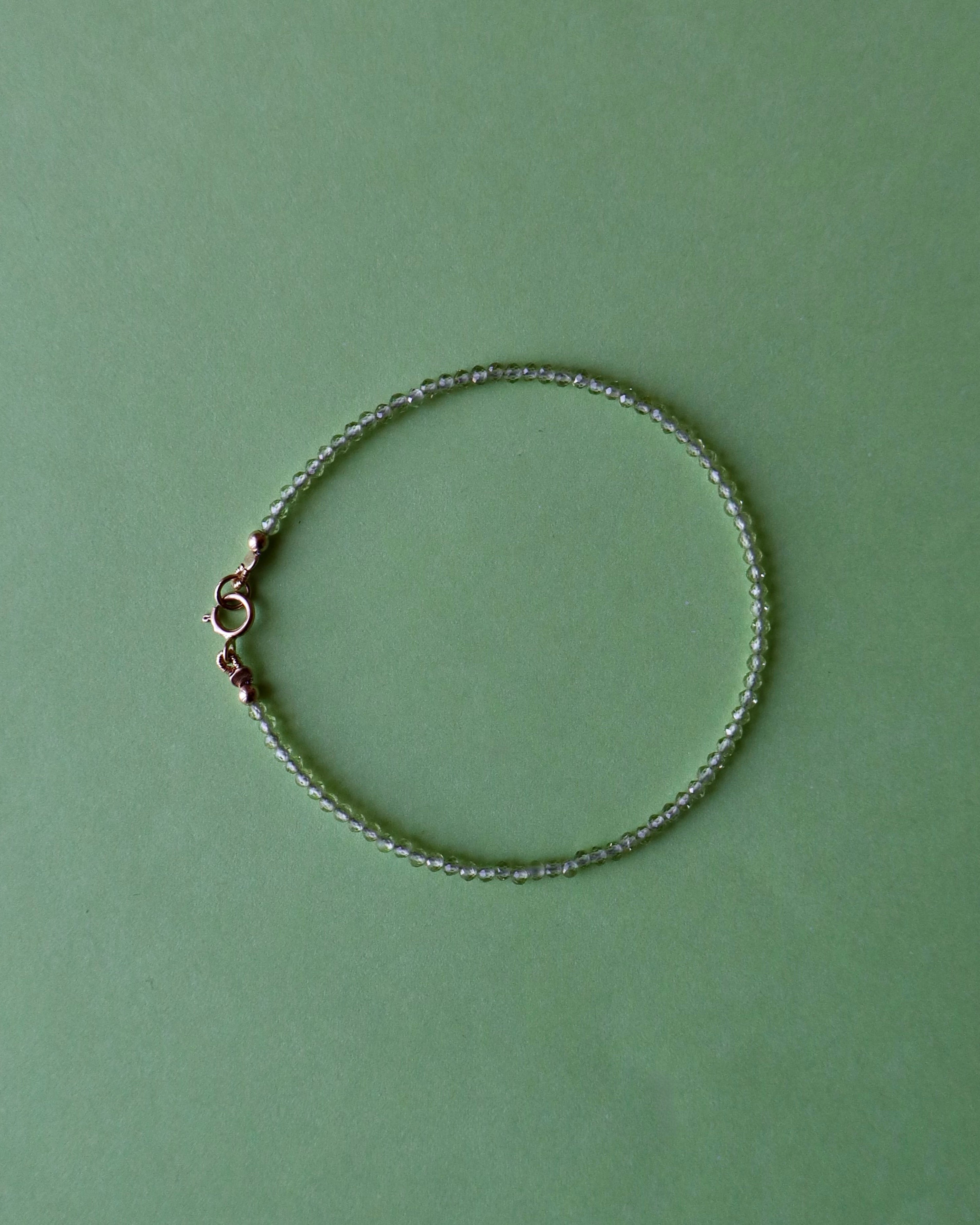 Silver bracelet on a green background