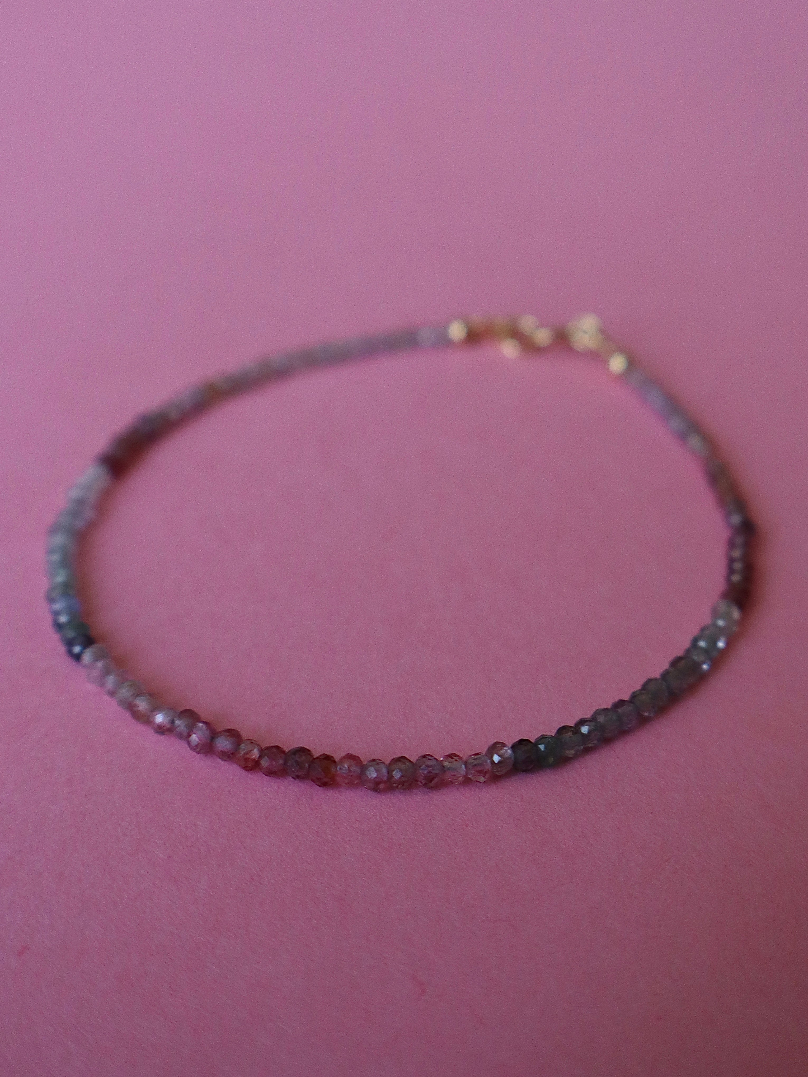 Multicolored beaded bracelet on a pink background