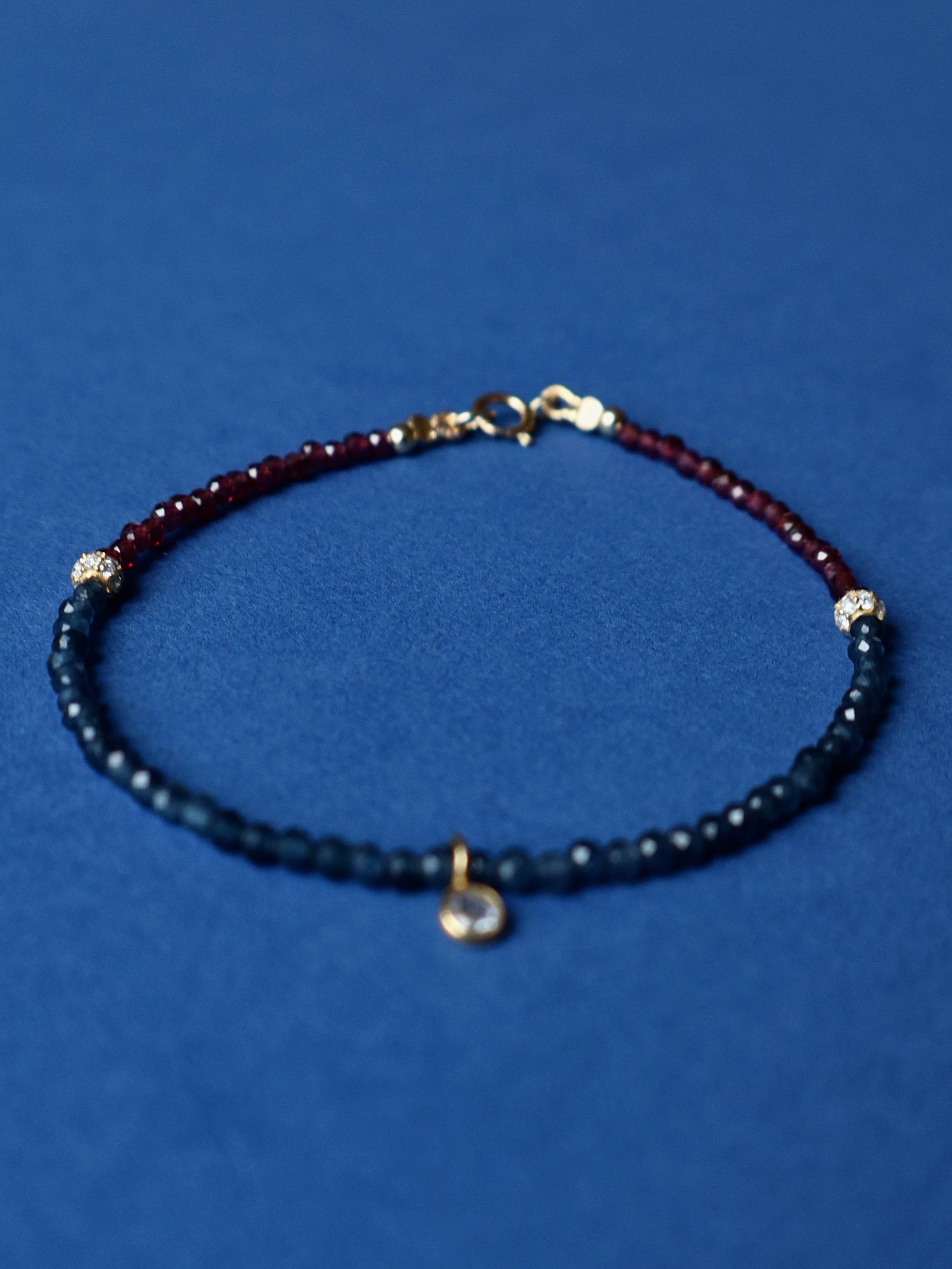 Beaded bracelet with red and blue beads on a blue background